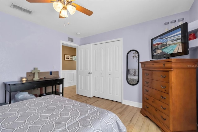 bedroom with a closet, light hardwood / wood-style flooring, and ceiling fan