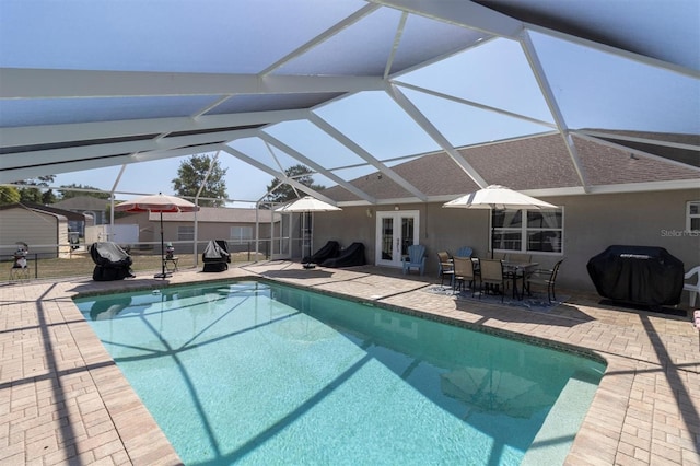 view of swimming pool featuring french doors, glass enclosure, grilling area, and a patio