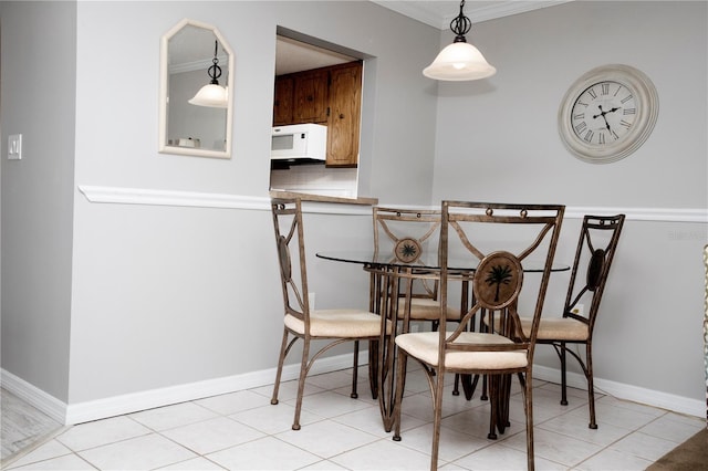 tiled dining room with ornamental molding