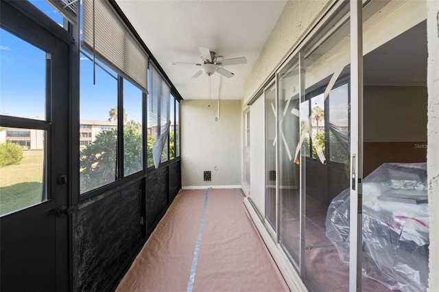 sunroom featuring ceiling fan