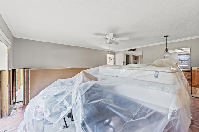 bedroom with ornamental molding, ceiling fan, and a textured ceiling