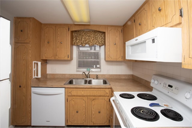 kitchen featuring tasteful backsplash, sink, and white appliances