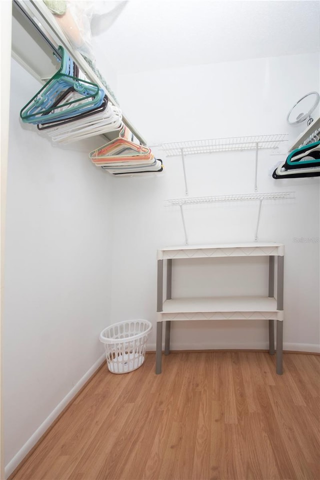 spacious closet with light hardwood / wood-style floors