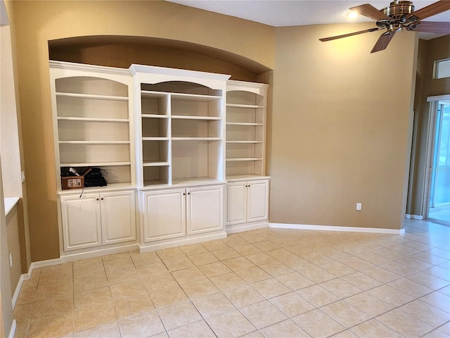 tiled spare room with built in features and ceiling fan