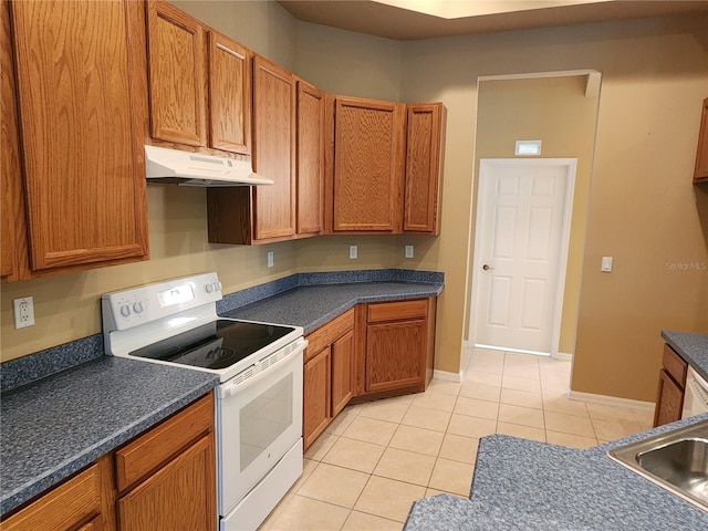 kitchen featuring sink, light tile floors, and white electric range oven