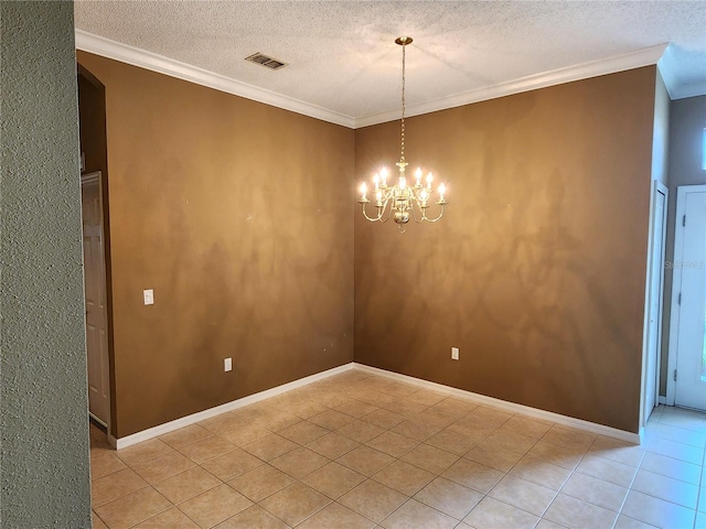 spare room with a chandelier, ornamental molding, a textured ceiling, and light tile flooring