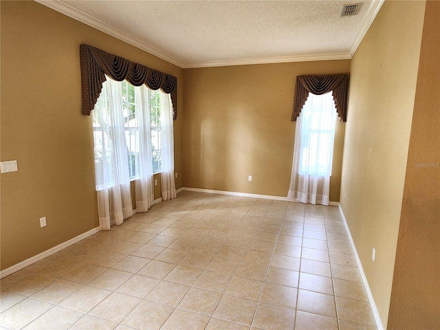 tiled spare room featuring ornamental molding and a textured ceiling