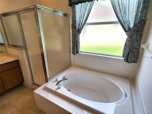 bathroom with vanity, shower with separate bathtub, and tile flooring