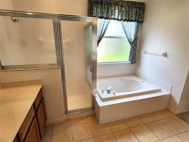 bathroom featuring tile flooring, vanity, and separate shower and tub