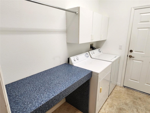 laundry area with cabinets, light tile floors, hookup for a washing machine, and washing machine and clothes dryer