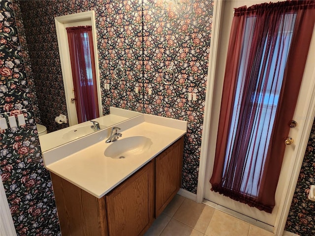 bathroom with vanity, tile floors, and toilet