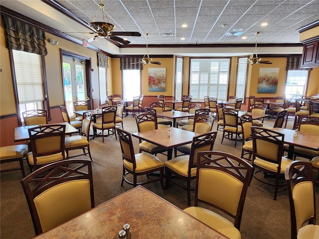 dining space with ornamental molding, ceiling fan, and a healthy amount of sunlight