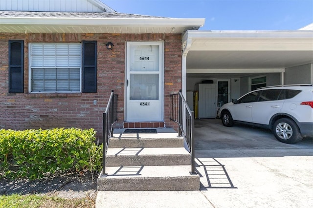 property entrance featuring a carport