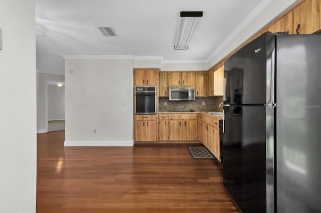 kitchen featuring dark hardwood / wood-style floors, tasteful backsplash, black appliances, sink, and ornamental molding