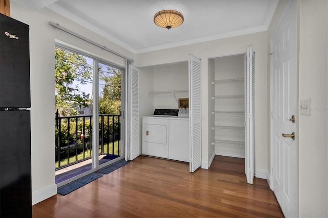 interior space featuring black fridge, separate washer and dryer, access to outside, hardwood / wood-style floors, and a closet