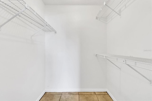 spacious closet featuring tile floors