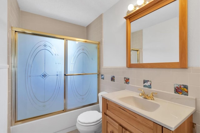 full bathroom featuring backsplash, combined bath / shower with glass door, toilet, and vanity with extensive cabinet space