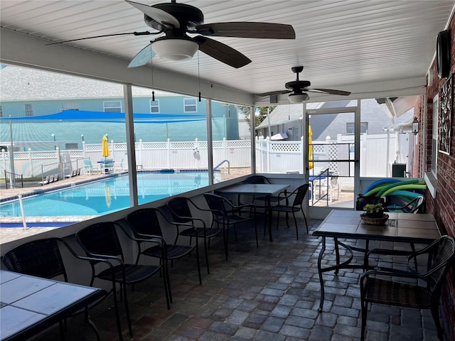 sunroom / solarium featuring ceiling fan