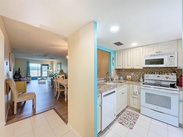 kitchen featuring ceiling fan, white appliances, sink, and light tile flooring