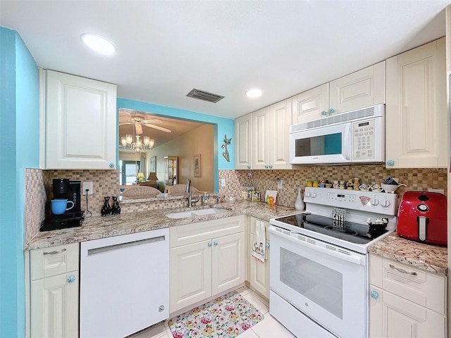 kitchen featuring white cabinets, sink, white appliances, backsplash, and light tile flooring