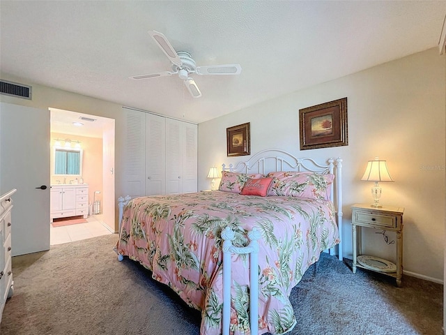 bedroom featuring connected bathroom, a closet, ceiling fan, and carpet floors