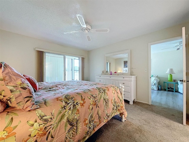 carpeted bedroom with a textured ceiling and ceiling fan