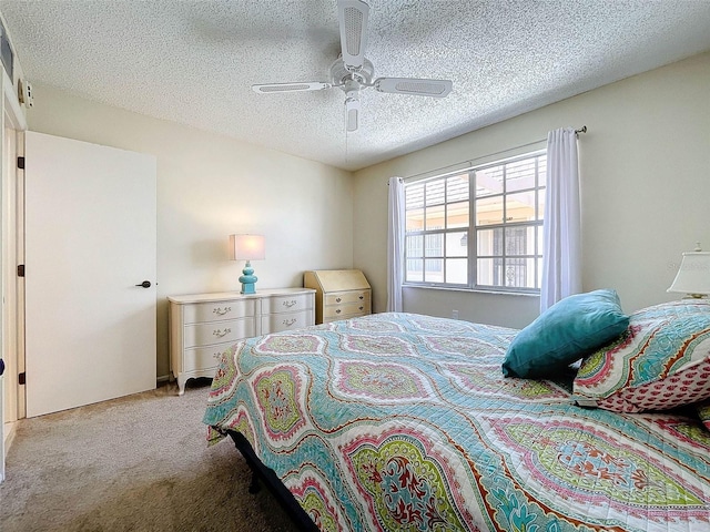 bedroom with light colored carpet, ceiling fan, and a textured ceiling