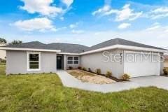 ranch-style house featuring a front lawn and a garage