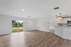 unfurnished living room with hardwood / wood-style flooring