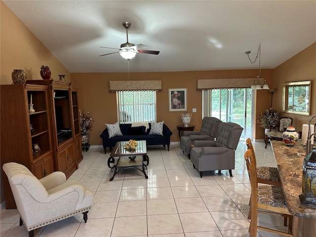 tiled living room featuring ceiling fan, plenty of natural light, and vaulted ceiling