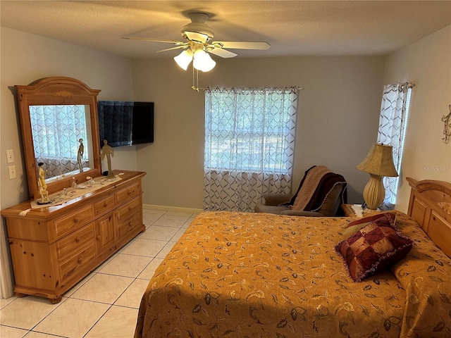 tiled bedroom featuring a textured ceiling and ceiling fan