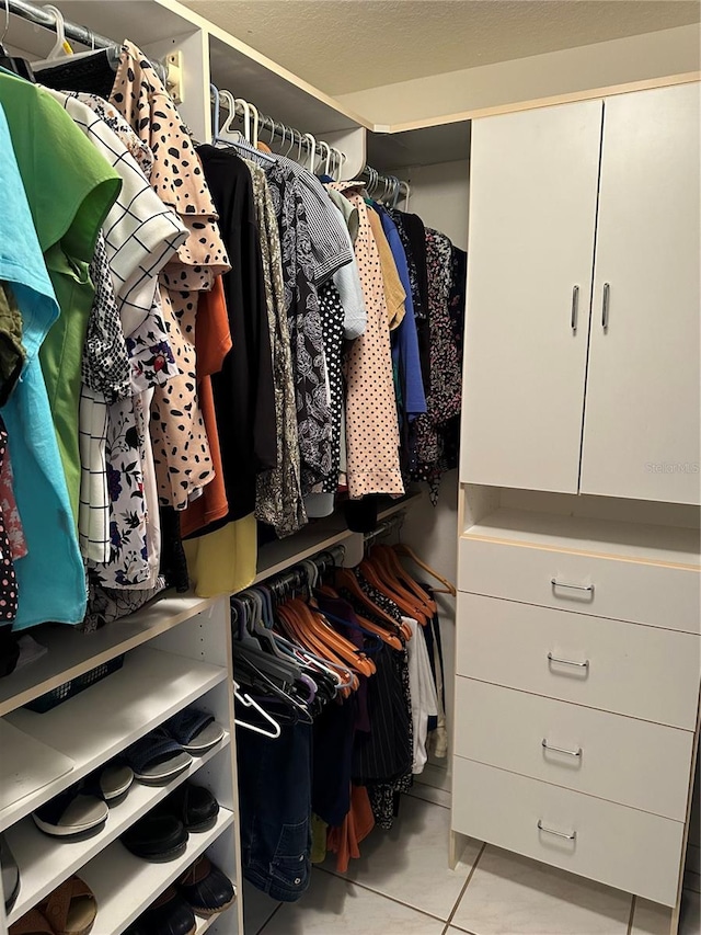 spacious closet with light tile patterned flooring