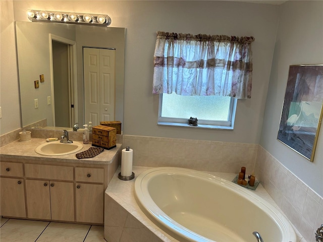 bathroom featuring tile patterned flooring, vanity, and a relaxing tiled tub