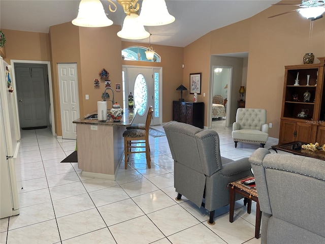 living room with light tile patterned floors, ceiling fan with notable chandelier, and vaulted ceiling