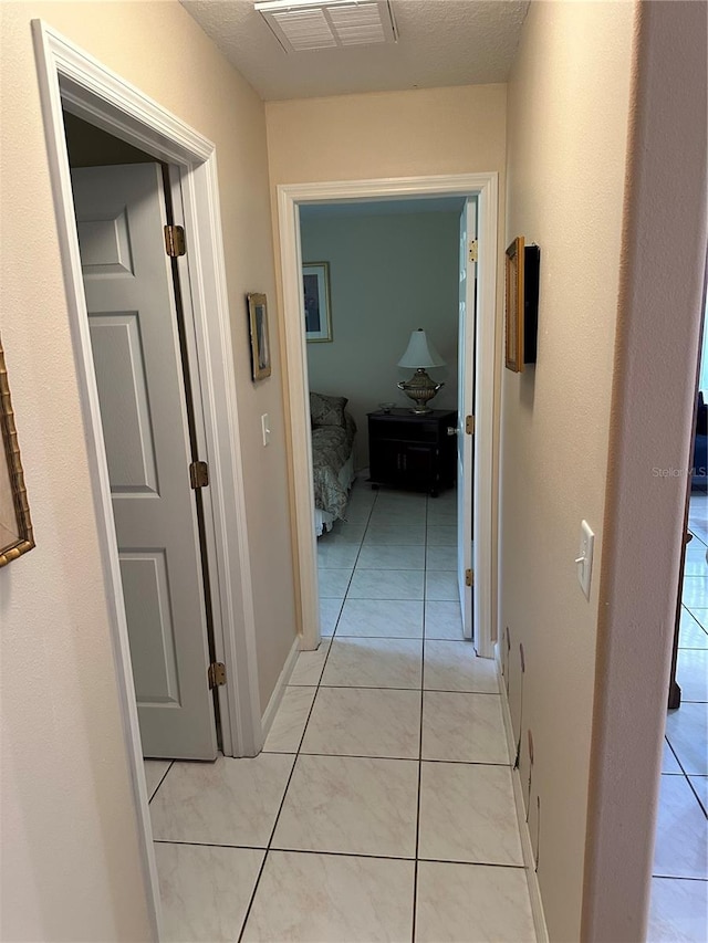 hallway with light tile patterned flooring