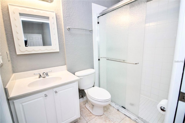 bathroom with tile floors, an enclosed shower, toilet, and vanity