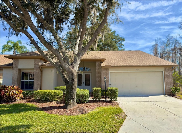 ranch-style home with a garage and a front lawn