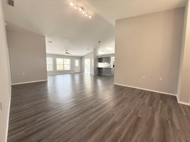 unfurnished living room with vaulted ceiling and dark hardwood / wood-style flooring