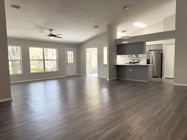 unfurnished living room featuring high vaulted ceiling, dark hardwood / wood-style floors, and ceiling fan