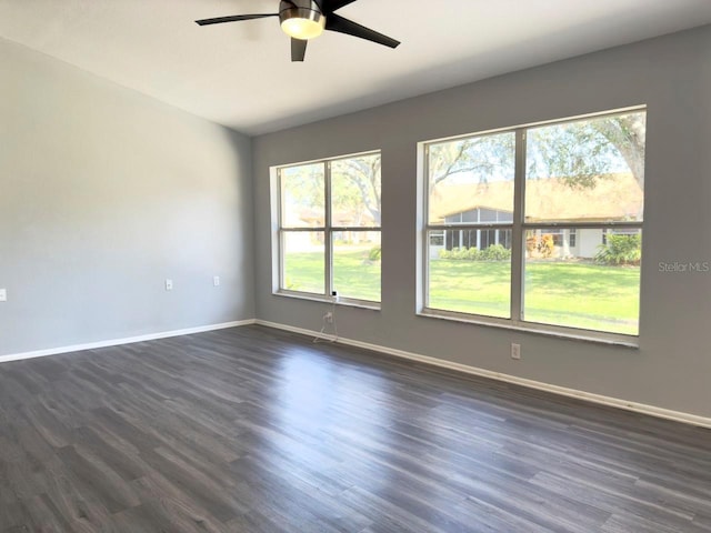 empty room with dark wood-type flooring and ceiling fan