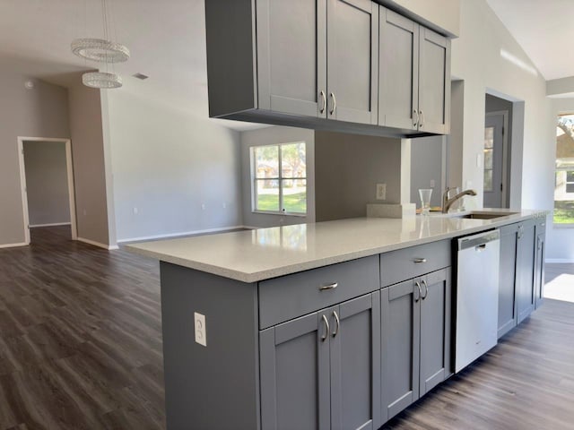 kitchen with sink, dishwasher, gray cabinetry, dark hardwood / wood-style flooring, and vaulted ceiling