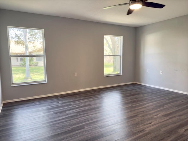 unfurnished room with dark wood-type flooring and ceiling fan