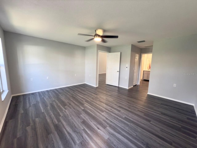 unfurnished room featuring dark wood-type flooring and ceiling fan