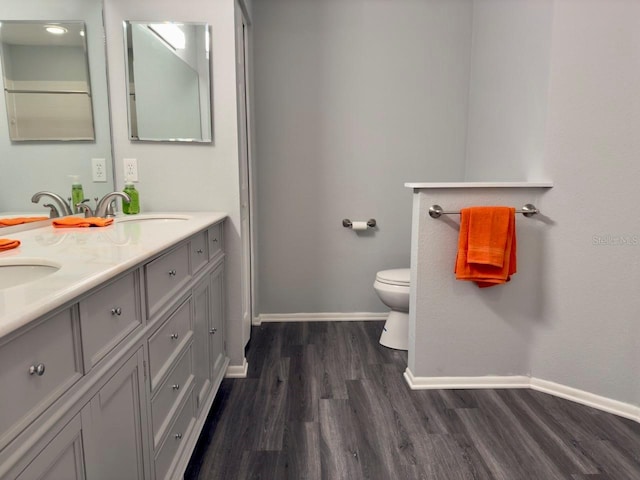 bathroom with vanity, hardwood / wood-style floors, and toilet