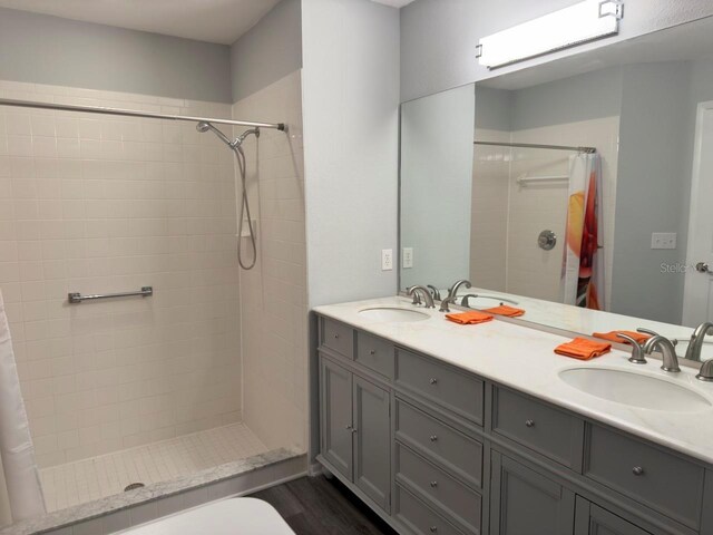 bathroom featuring vanity, hardwood / wood-style flooring, and curtained shower