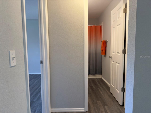 hallway with dark wood-type flooring