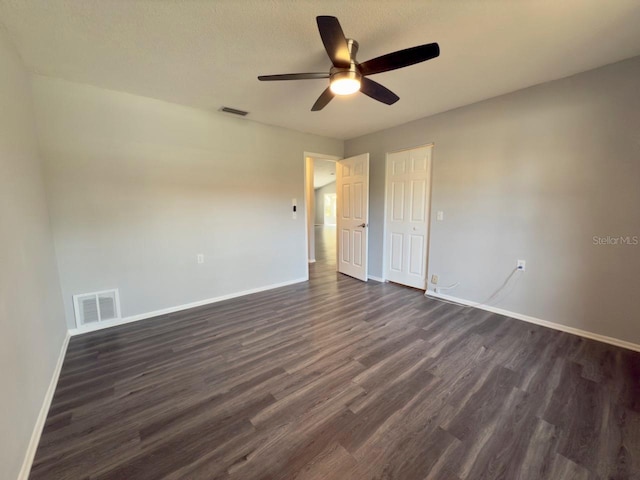 unfurnished bedroom featuring ceiling fan, dark hardwood / wood-style flooring, and a textured ceiling