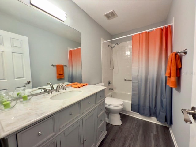 full bathroom with wood-type flooring, toilet, shower / tub combo, and vanity