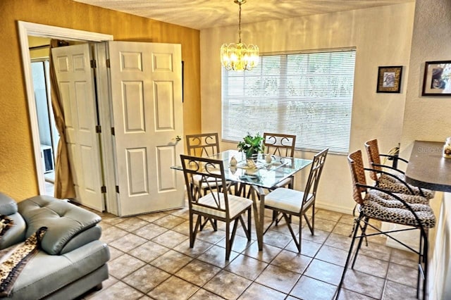 dining area with a notable chandelier and tile flooring