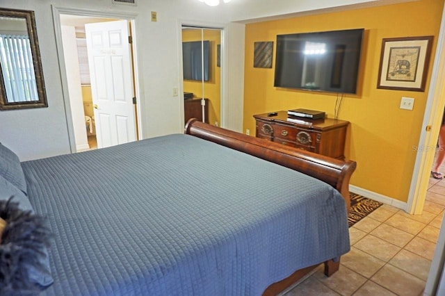 bedroom featuring tile flooring and a closet